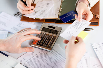 Close Up of Two Startup Employees Calculating Monthly Expenses