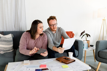 Middle Aged Couple Calculates and Accounts For Annual Bank Statements