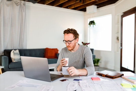 Red Haired Man Accounting For His Startup Company's Annual Expenses