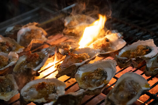 Oysters grilled on the fire, delicious barbecue