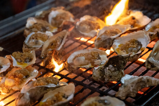 Oysters grilled on the fire, delicious barbecue