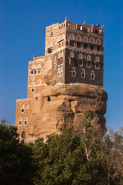 the royal palace of dar alhajar stands on top of a rock 