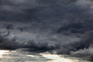 Naklejka na ściany i meble Dark clouds before a thunderstorm . Hurricane heaven . Black sky before storm 