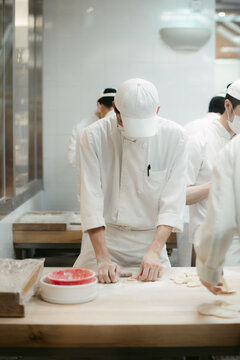 Faceless chefs cooking in restaurant kitchen
