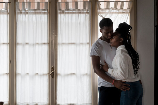 Pensive Black Couple looking out of the window