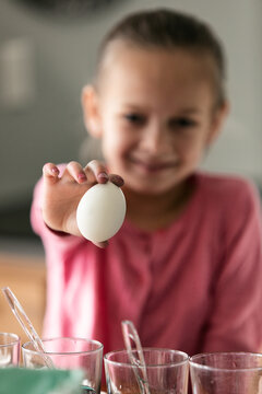 Girl Holds Egg Before Coloring