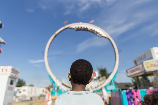 Boy framed against carnival ride