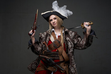 Woman buccaneer dressed in pirate suit and hat