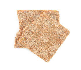 Pieces of crunchy rye crispbread on white background, top view