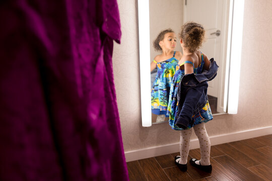 Girl struts for dressing room mirror
