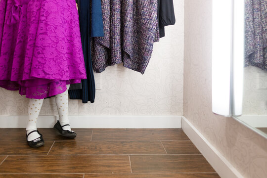 Girl hides in clothes in dressing room