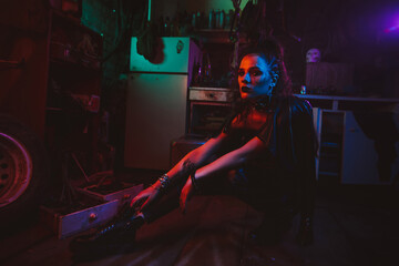 Cyberpunk girl in a steampunk costume in a garage with neon lighting