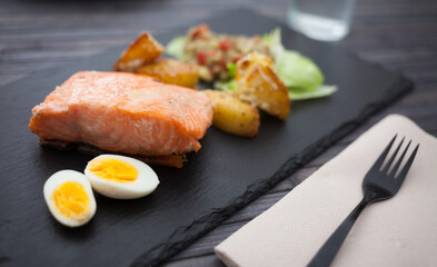 steamed salmon fillet with potato wedges, guacamole homemade and quail egg