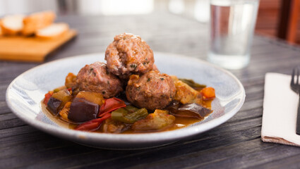 cooked meatballs with stewed eggplant with haze in bowl