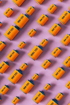 Orange film rolls on pink background