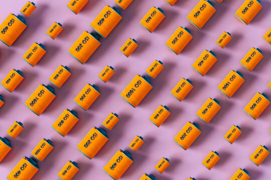 different size of Orange film rolls on pink background - pattern