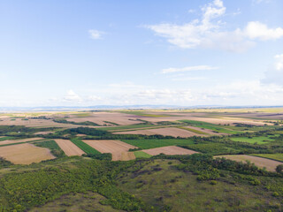 Fototapeta na wymiar Fertile fields and blue sky in Serbia. Aerial photography. 