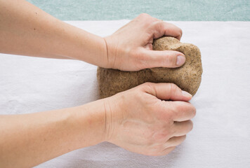 Women's hands knead dough for homemade bread. Step by step bread recipe. Baking process. Homemade organic bread. Photos with step by step recipe