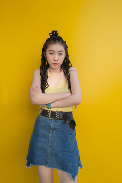 Fashion young Asian woman portrait on yellow background