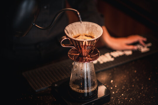 Cafe staff pour hot water into coffee beans to drip coffee for good smell and good quality serve customers ,who order to taste.