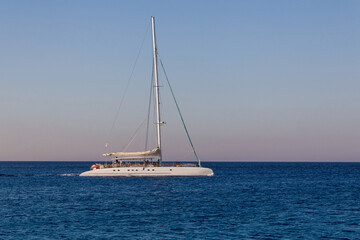 Fototapeta premium Yacht on the horizon of the seascape