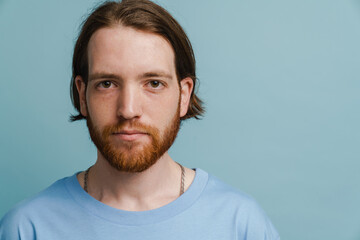 Young ginger man with beard posing and looking at camera