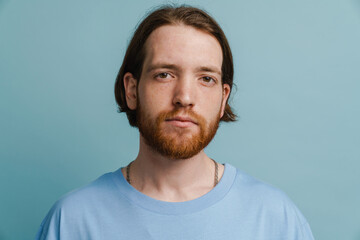 Fototapeta premium Young ginger man with beard posing and looking at camera