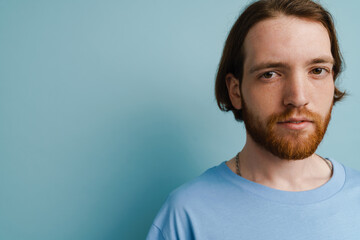 Fototapeta premium Young ginger man with beard posing and looking at camera