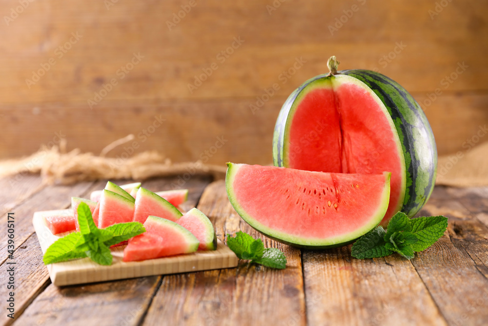 Sticker juicy watermelon and slices on wooden board