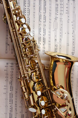 closeup of gold saxophone on sheet music