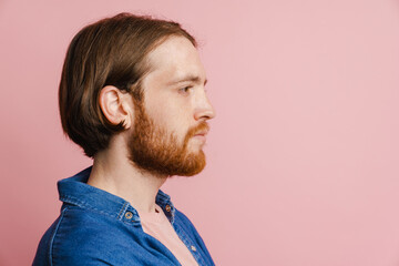 Young ginger man with beard posing and looking aside