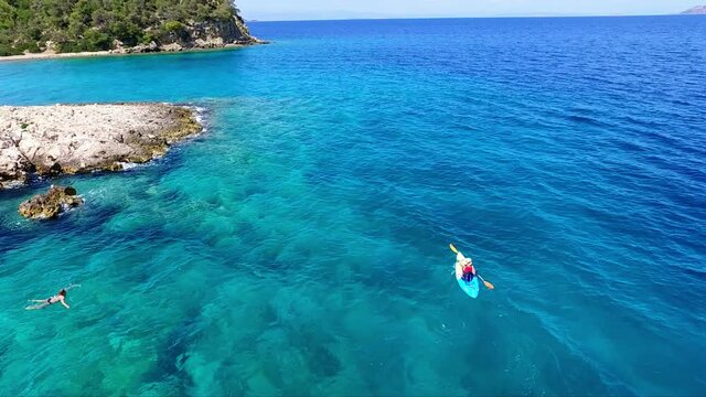 4K aerial shot of kayaking in the blue and turquoise waters of the Argolid, Peloponnese, Greece
