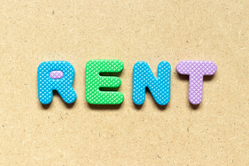 Foam alphabet letter in word rent on wood background