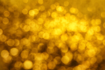 Blurred view of golden lights as background. Bokeh effect