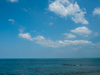 blue sky fluffy white clouds above the ocean. horizon at sea.