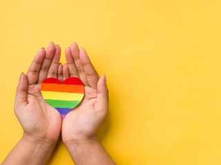 Rainbow color heart on hand for lgbtq community.