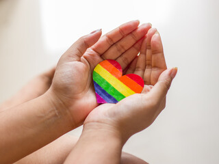 Rainbow color heart on hand for lgbtq community.