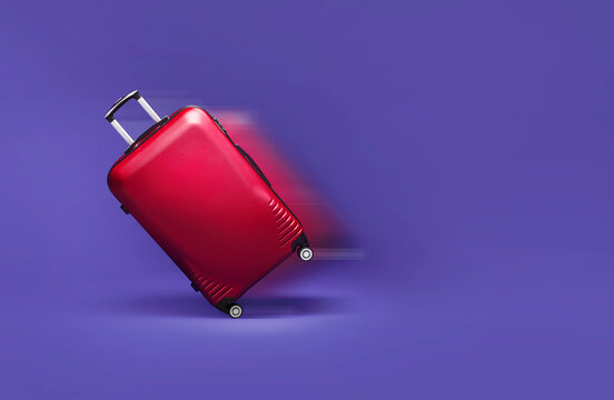 Red suitcase rolling fast on a purpple background