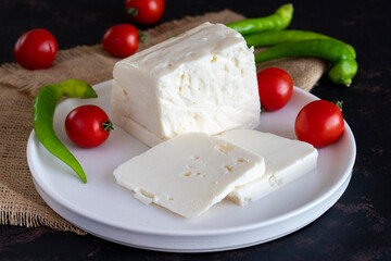 Sliced feta cheese on dark background