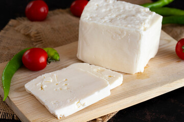 Sliced feta cheese on dark background