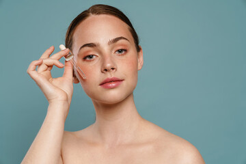 Portrait of a young healthy white woman holding bottle