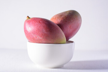 Fresh palmer mango fruit in bowl on white background, Tropical fruit	 - obrazy, fototapety, plakaty
