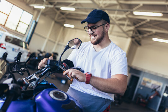 Professional motorcycle mechanic working in bike repair service
