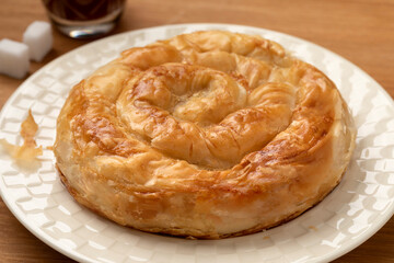 Single traditional Turkish borek stuffed with cheese on a plate 