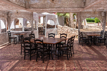 Wooden table and chairs in beach cafe next to the red sea in Sharm el Sheikh, Egypt