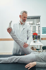 Vertebrologist performing a straight leg raise test