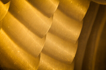 Part of the ship's bronze propeller, close-up. New polished bronze texture. Uneven surface of...