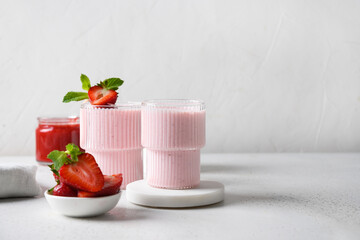 Strawberry lassi or milkshake on a white background with copy space. Close up. Healthy dairy Indian...