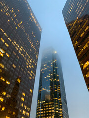 skyscrapers at night in fog