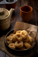 Indian traditional sweet balushahi served on a metal plate on wooden background